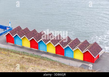 Brightly painted beach huts, Whitby, Yorkshire, England, UK Stock Photo