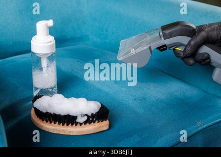 Close up of detergent tools and extraction vacuum used for deep cleaning upholstered furniture Stock Photo