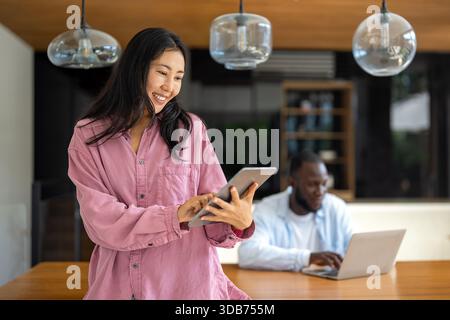 Couple of freelance IT specialists using digital technology devices while working remotely from home Stock Photo