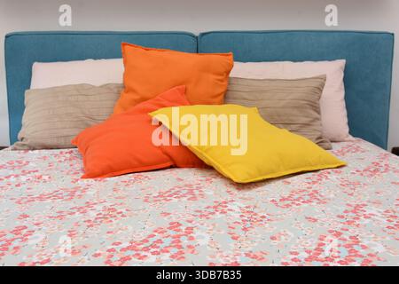cushions representing autumn placed on the bed Stock Photo