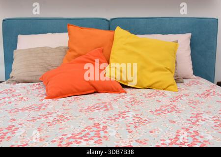 cushions representing autumn placed on the bed Stock Photo