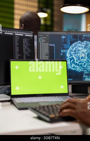 Mockup laptop used by software developer in AI tech company workspace to conduct code reviews. IT expert using isolated screen notebook at office desk to design and implement deep learning algorithms Stock Photo