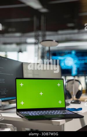 Green screen laptop in empty AI startup office used by programmers building scalable solutions for businesses. Mockup notebook in Silicon Valley workplace leveraging machine learning technology Stock Photo
