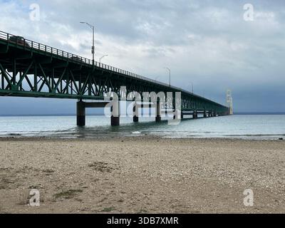 Wide View of Mackinac Bridge from a Gravel Beach Shoreline. Stock Photo