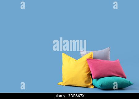Different colorful pillows on blue background Stock Photo
