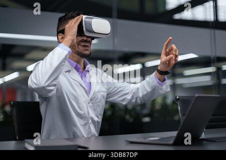 Man Using Virtual Reality Headset in Office Setting During Work Hours Stock Photo