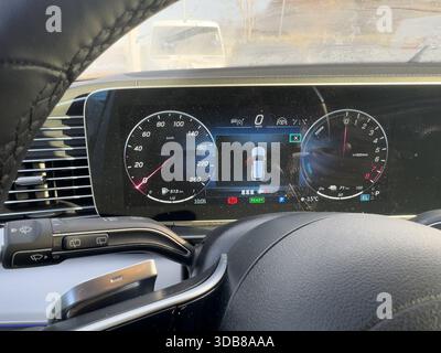 Modern car dashboard showing digital speedometer, tachometer, and vehicle status Stock Photo