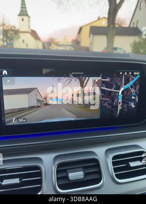Car dashboard displaying a split screen with augmented reality gps navigation and map view Stock Photo