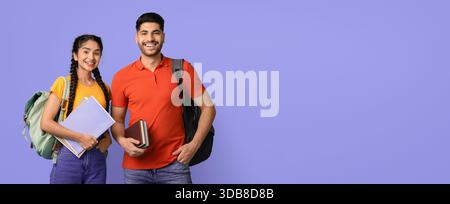 Two Students Smiling Together With Backpacks and Books in a Colorful Setting Stock Photo