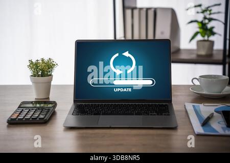Update software application Person using laptop with software update progress interface and security, technology update digital transformation concept Stock Photo