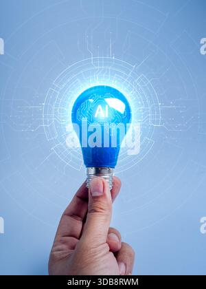 Hand holding glowing blue light bulb with AI brain circuit design on blue background, symbolizing artificial intelligence, machine learning, and innov Stock Photo