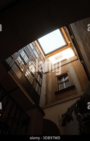 Sunlight streams through aged windows, illuminating textured walls and creating a warm, inviting atmosphere. Stock Photo