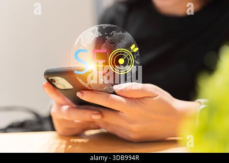 SEO search optimization concept with smartphone and global target icon, representing digital marketing strategy, traffic growth, data analytics, AI op Stock Photo