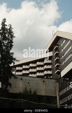 Striking architectural design featuring a tall building with unique repeating balcony features, bathed in sunlight. Stock Photo