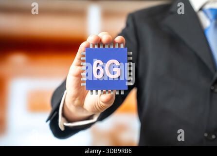 Businessman holding a new 6G microchip. Internet of Things. An innovative communication standard. Ultra fast connectivity and network evolution. Telec Stock Photo