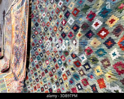 Close-up of a colorful, hand-woven carpet with geometric patterns Stock Photo