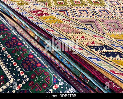 Vibrant geometric patterns on Central Asian folded carpets. Stock Photo