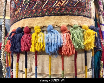 Colorful wool tassels decorating a traditional Central Asian textile Stock Photo