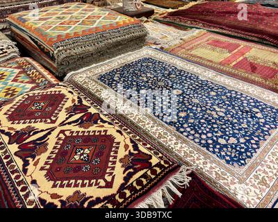 Blue floral and geometric Central Asian carpets on display. Stock Photo