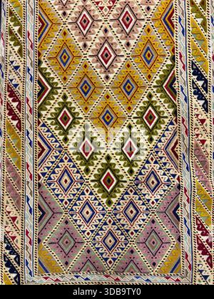 Vibrant close-up of intricate, traditional geometric carpet pattern. Stock Photo