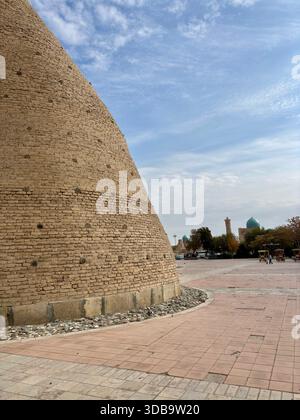 Massive curved mud brick fortress wall buttress near Bukhara Stock Photo