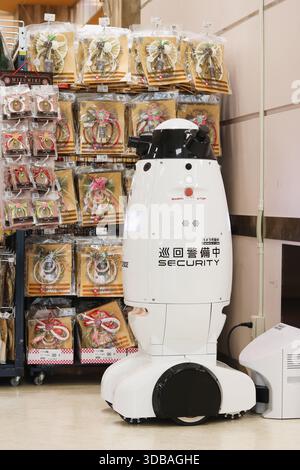 TOKYO, JAPAN - December 6, 2025: A Seqsense robot at its recharging dock in a supermarket.  It is next to some New York decorations. Stock Photo