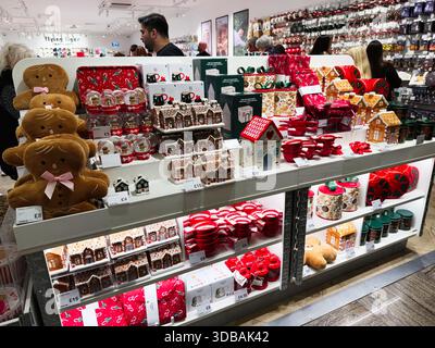 Stretford, UK - November 15, 2025: Colorful Christmas display with gingerbread treats, ornaments, and decorative gifts in a busy Manchester store. Stock Photo