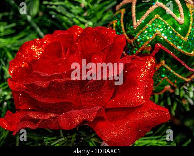 Red Glitter Rose and Green Ornament with Gold Zigzag Pattern in Christmas Tree Close-Up Festive Celebration Holiday Background Stock Photo