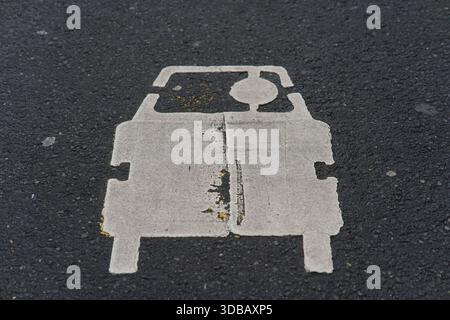 White car symbol painted on asphalt indicating a traffic or parking marking on a city street in Nantes, France.Nantes,France Stock Photo