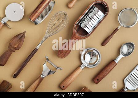Various kitchen utensils or cooking tools on brown background, top view, flat lay. Stock Photo
