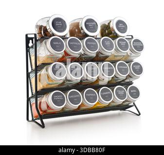 Assorted spices in glass jars with metal lids on a black metal shelf isolated on white background, clipping path included. Stock Photo