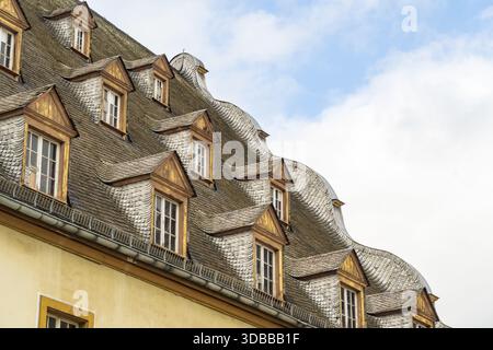 View of an old building with many windows on the roof against a partly cloudy sky, Koblenz Mitte, Rhineland-Palatinate, Germany. Stock Photo
