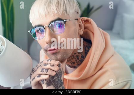 Young man in eyeglasses with reflection of business statistics in office Stock Photo