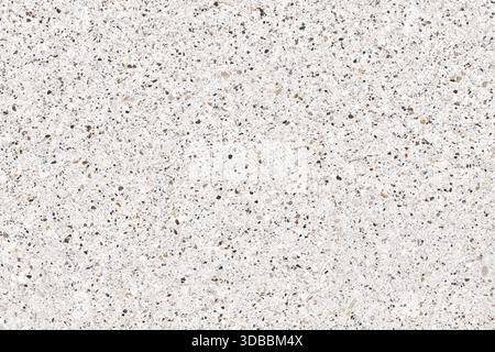 High-resolution seamless quartz background texture of a fine aggregate surface. Features a pattern of tiny pebbles and rock fragments on a white or pa Stock Photo