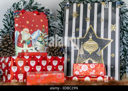 Christmas Gift Bags and Boxes with Pinecones and Tinsel at Christmas Stock Photo