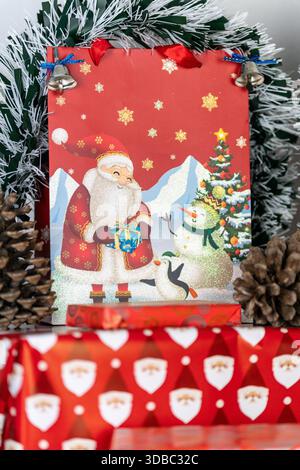 Christmas Gift Bag and Wrapped Present with Pine Cones and Tinsel close up Stock Photo