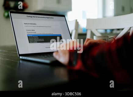 Middle Aged Man Applies for Student Loan Financial Aid and Scholarships - Never Too Late to Return to School - Adult Higher Education Growth Concept Stock Photo