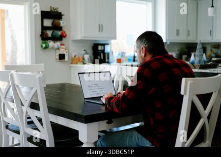 Middle Aged Man Applies for Student Loan Financial Aid and Scholarships - Never Too Late to Return to School - Adult Higher Education Growth Concept Stock Photo
