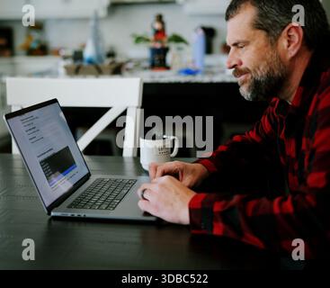 Middle Aged Man Applies for Student Loan Financial Aid and Scholarships - Never Too Late to Return to School - Adult Higher Education Growth Concept Stock Photo