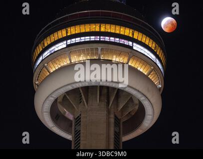 The blood moon lunar eclipse is seen behind the CN Tower in Toronto on Friday, March 14, 2025. THE CANADIAN PRESS/Frank Gunn Stock Photo