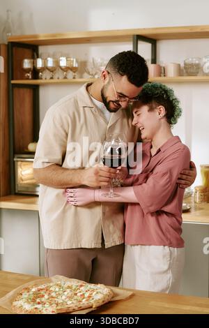 Young Woman with Prosthetic Arm Hugging Young Man Smiling Stock Photo