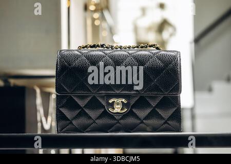 Nice, France - November 14, 2025: Black Chanel quilted handbag with gold chain displayed in a luxury boutique on Avenue Verdun in Nice Stock Photo