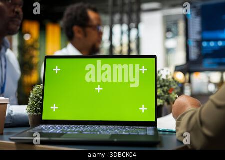 Isolated screen laptop used by engineers developing software, designing coding solutions together. Coworkers analyze technical issues with chroma key notebook, optimizing performance, closeup Stock Photo