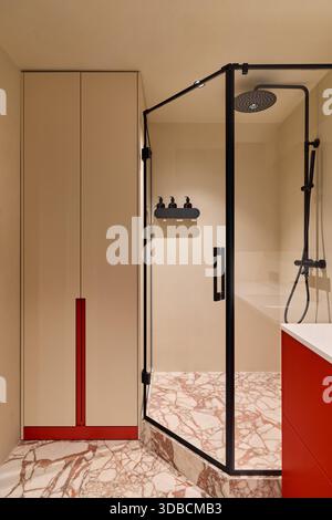 Stylish Modern Shower And Vanity, Luxurious Guest Bathroom Featuring Glass Shower And Bold Red Accents Stock Photo