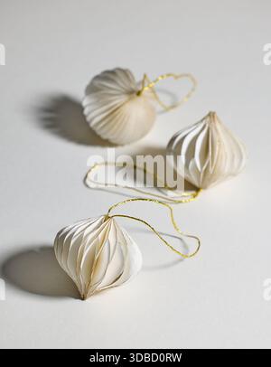 white paper Christmas ornaments on light grey background, selective focus Stock Photo