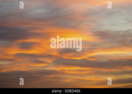 Dramatic evening sky with bright orange clouds in soft pastel shades, Baden-Wuerttemberg, Germany Stock Photo