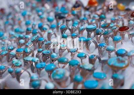 A bunch of Iranian traditional silver rings with ornamental stones on them, seen in an old bazaar. Stock Photo