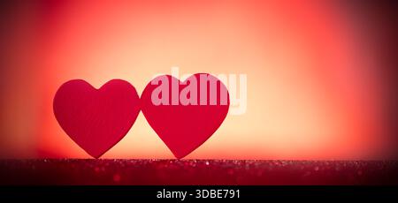 Two heart shapes side-by-side against an unclear background. A combination of love and affection. Stock Photo