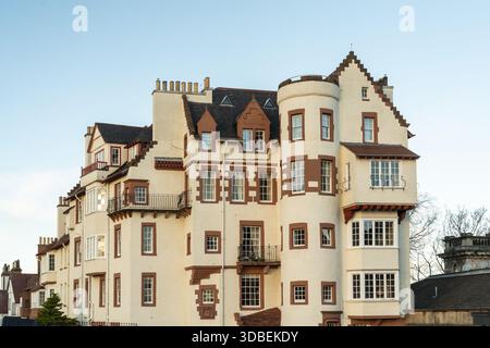 Cream colored building with red trim around windows and orange clay ...