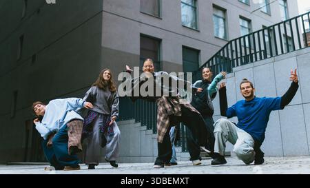 Hip hop group moving in sync during outdoor practice. Stock Photo